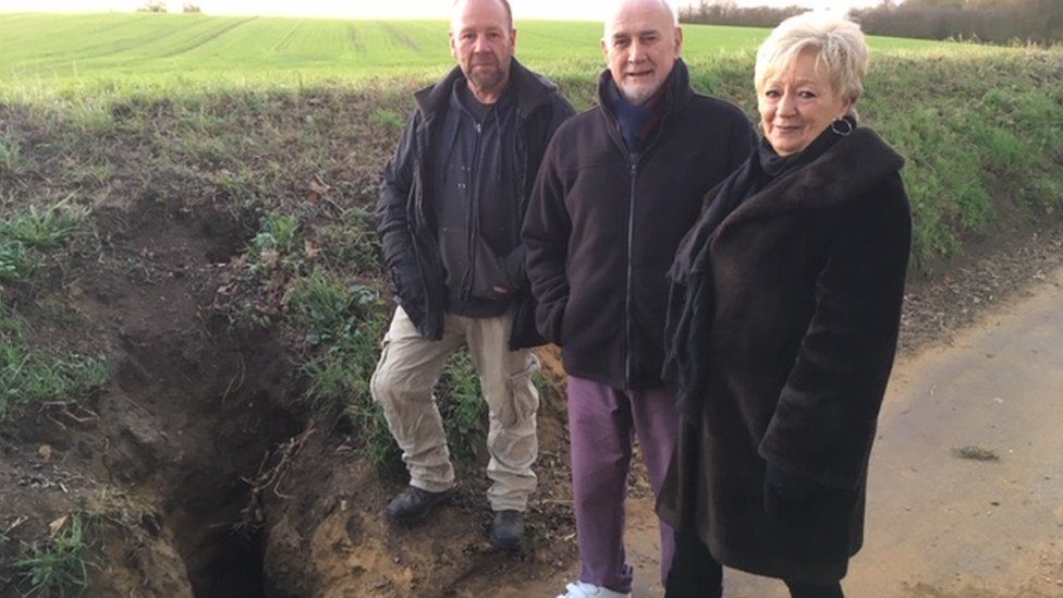 Nick Rix, Roger and Janet Dunnet (left to right) stand next to the badger sett in Flowton Road, Somersham