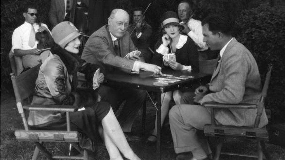 Circa 1928: Hollywood director King Vidor Jane Winton and actress Marion Davies learning the art of bridge from Milton York, the international player.