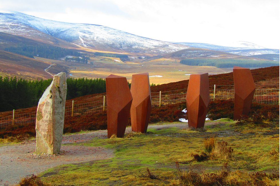 The Watchers standing sentinel to the east of The Lecht with the snow capped Cairngorms in the background.