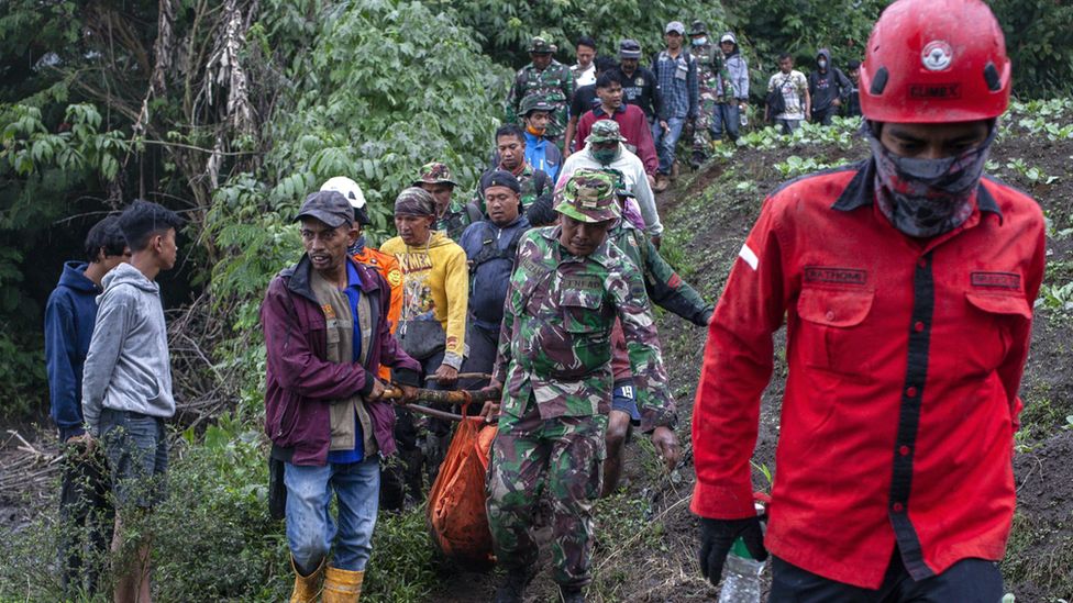 Rescuers carry the body of a hiker killed in the Mount Marapi eruption in Agam, West Sumatra, Indonesia, 05 December 2023.