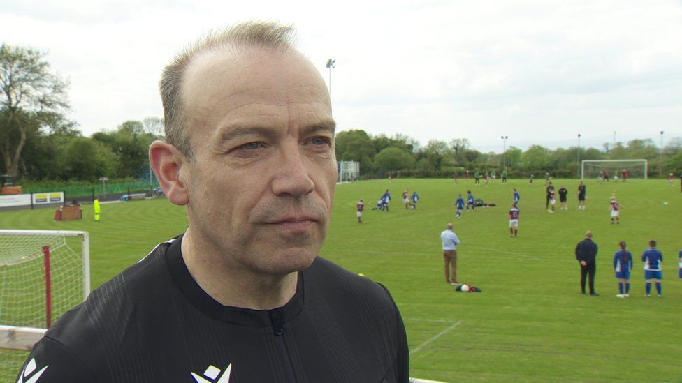 NI Secretary of State, Chris Heaton-Harris at a football pitch in south Antrim