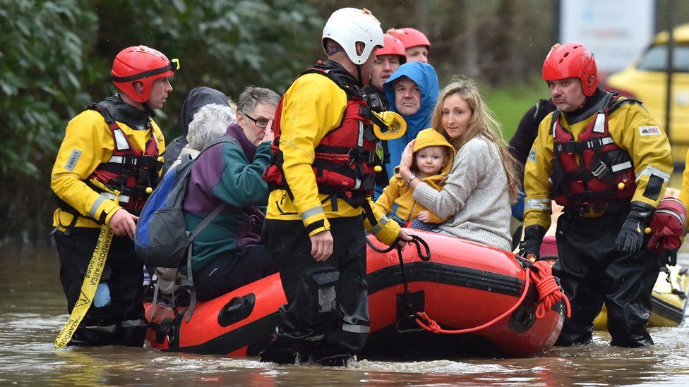 Residents of Nantgarw in a rescue boat as emergency services take people to safety, after flooding in the village in Wales