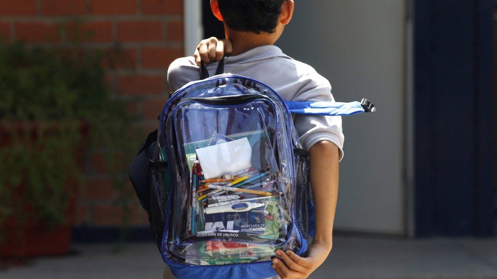 School student carrying clear backpack