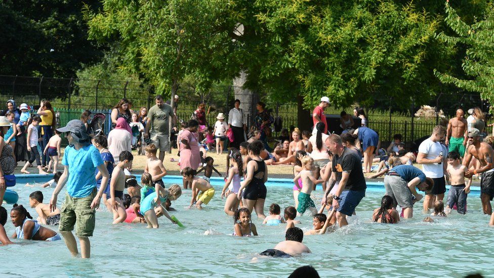 People in the paddling pool in Clissold Park, north London