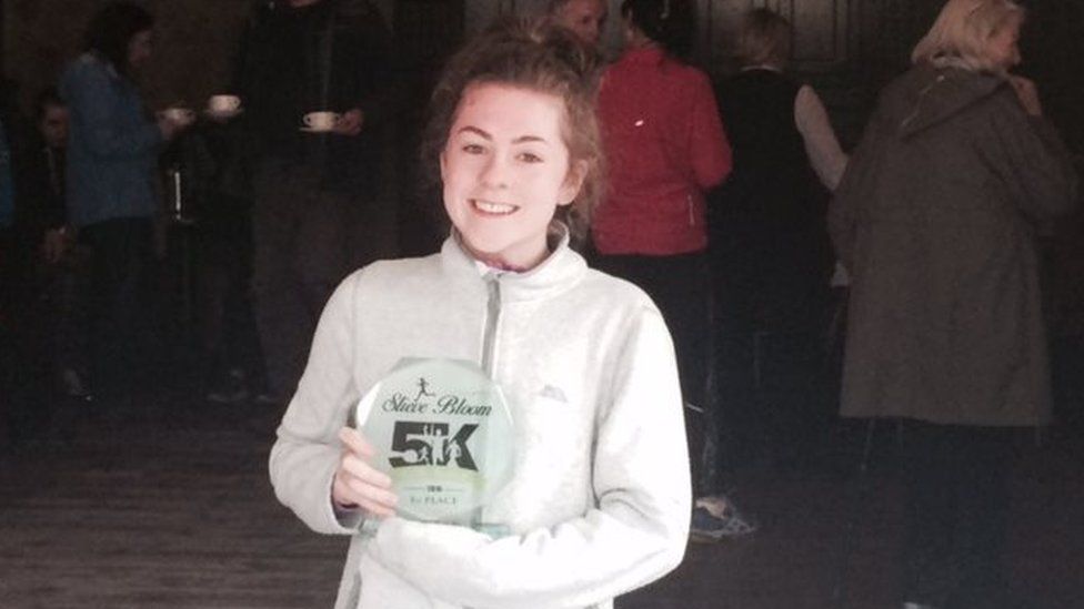 Katie Cooke with a running trophy