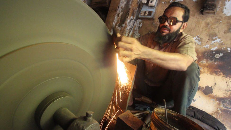 A technician sharpens a knife at a workshop in Mumbai, India on 24 July 2019. The International Monetary Fund (IMF) on Tuesday lowered the growth forecast for 2019-20 to 7% from 7.3% due to a weaker-than-expected outlook for domestic demand as per media report