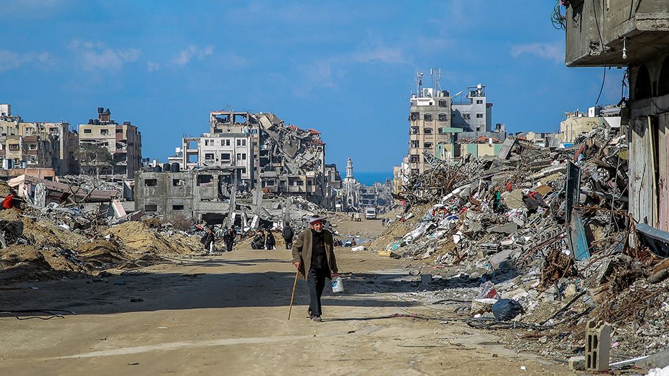 Man walks through destroyed streets of Gaza City in February 2024
