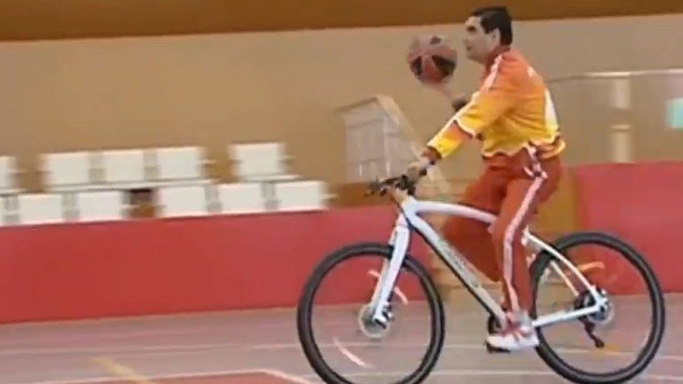 Kurbanguly Berdymukhamedov playing basketball on a bicycle