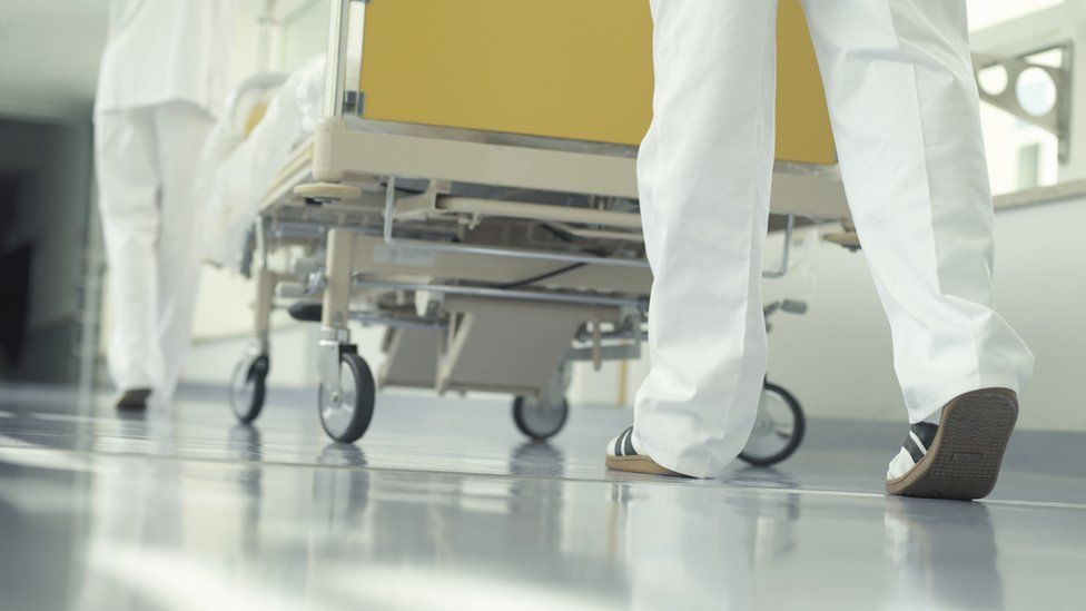 Wheeling a patient through a hospital