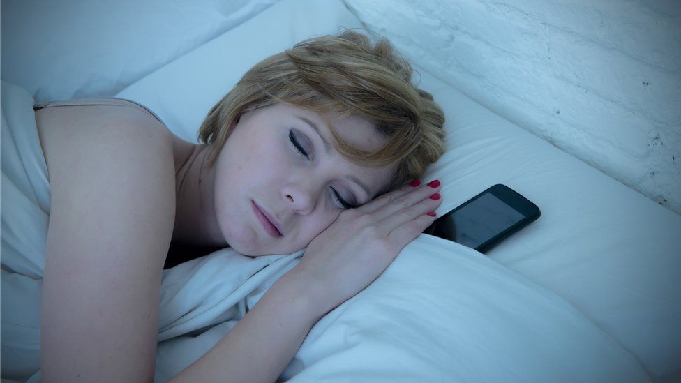 sleeping woman with a phone