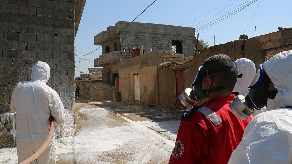 Members of the civil defence spray and clean areas in the town of Taza, around 220 kilometres north of the capital Baghdad, on 13 March 2016, that might have been contaminated in a chemical attack carried out by the Islamic State (IS) group the previous week.