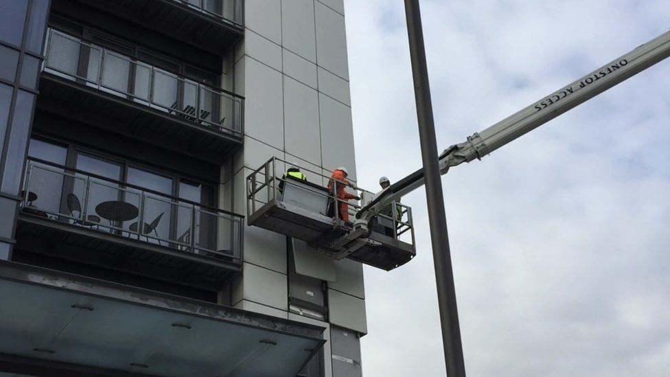 Surveyors remove a sample of the cladding from one of the Glasgow Harbour properties
