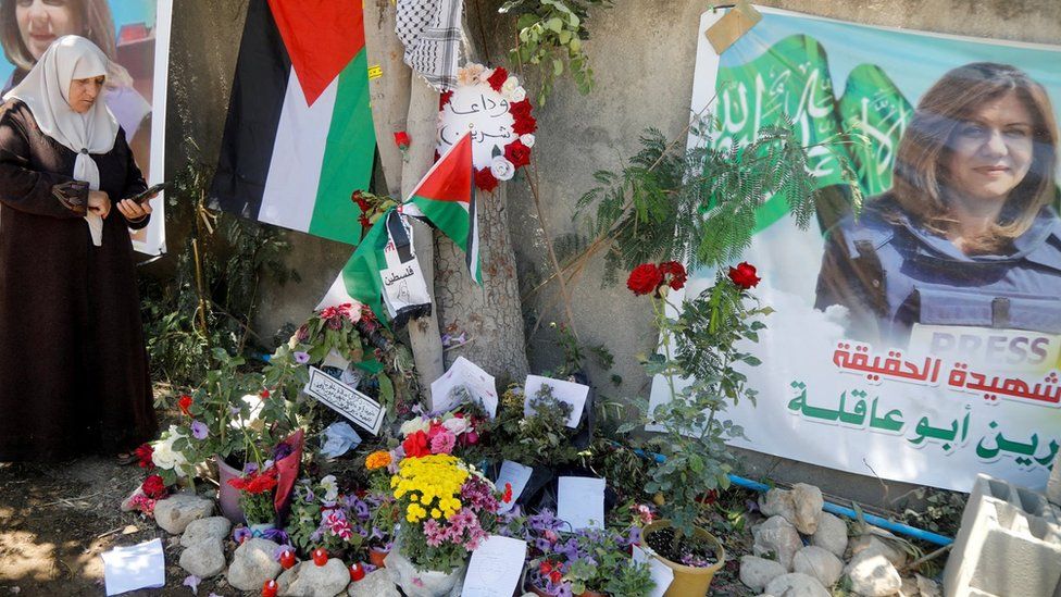 File photo showing a Palestinian woman taking pictures next to where Al Jazeera reporter Shireen Abu Aqla was shot dead, in Jenin, in the occupied West Bank (17 May 2022)