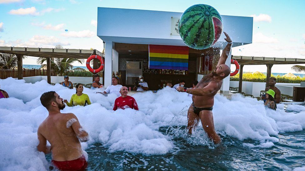 Guests have fun at a foam party at the Gran Muthu Rainbow Hotel, at Guillermo Key in Ciego de Avila Province, Cuba, on 28 November 2021
