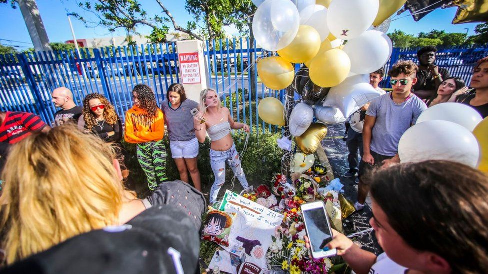 Fans leave balloons and tributes to him at the scene of killing