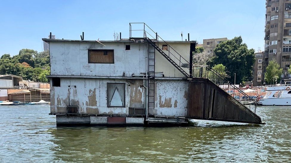 A houseboat is towed away by Egyptian authorities on 28 June 2022