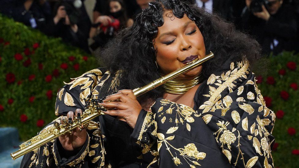 Lizzo playing a flute