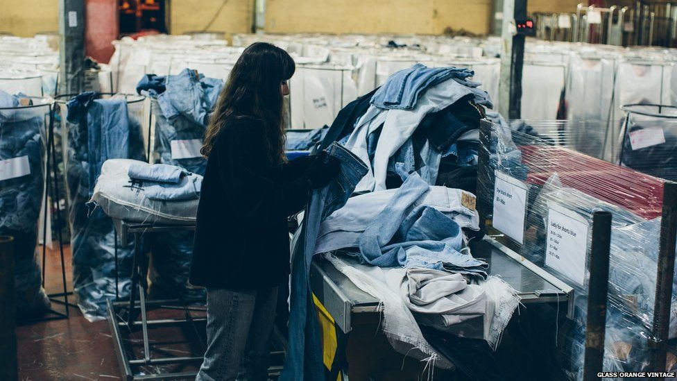 A woman sorting through recycled denim