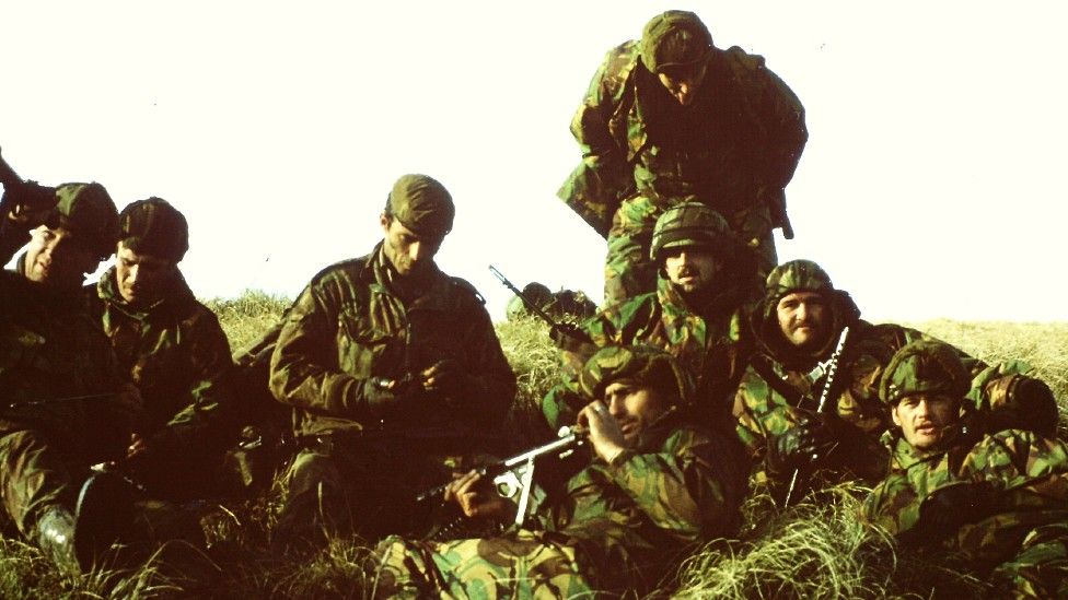 Soldiers lying on the grass in the Falklands