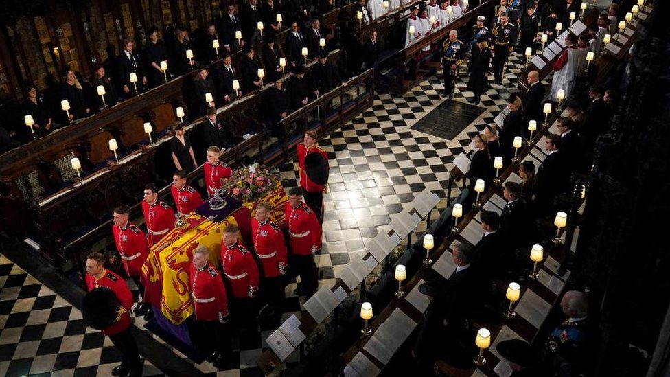 The coffin of Queen Elizabeth II is carried into St George's Chapel in Windsor followed by members of the Royal Family