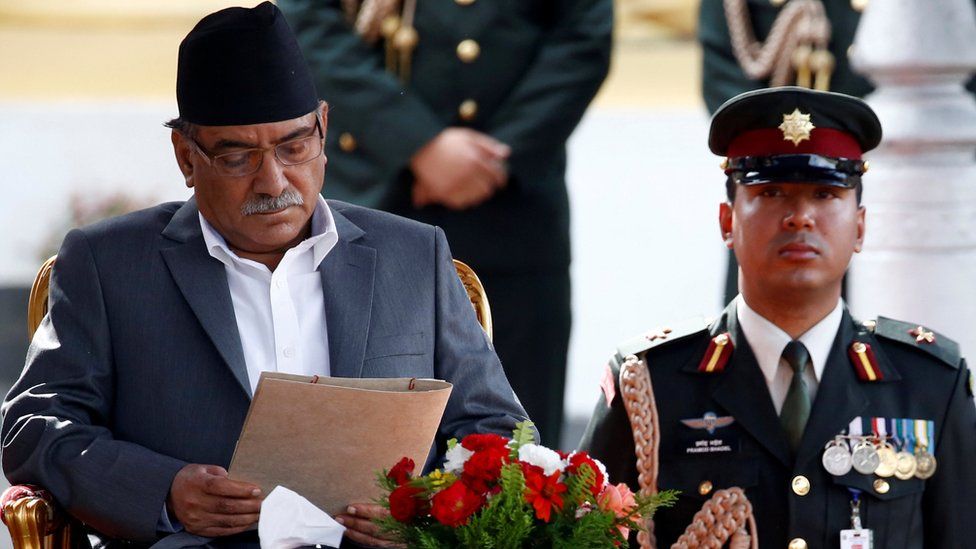Newly elected Nepalese Prime Minister Pushpa Kamal Dahal, also known as Prachanda, (L) preparing to be sworn in at the presidential building in Kathmandu