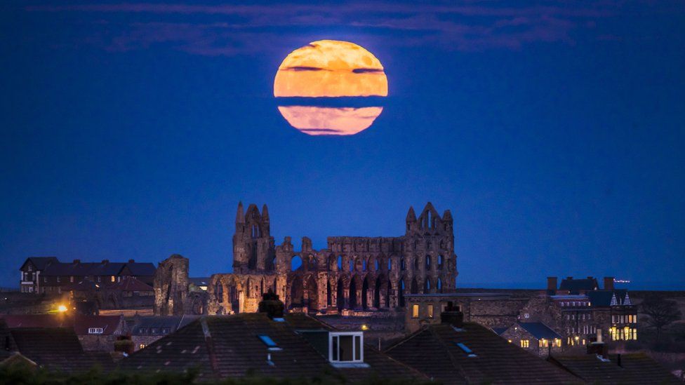 The "supermoon" rising above Whitby Abbey in Yorkshire.