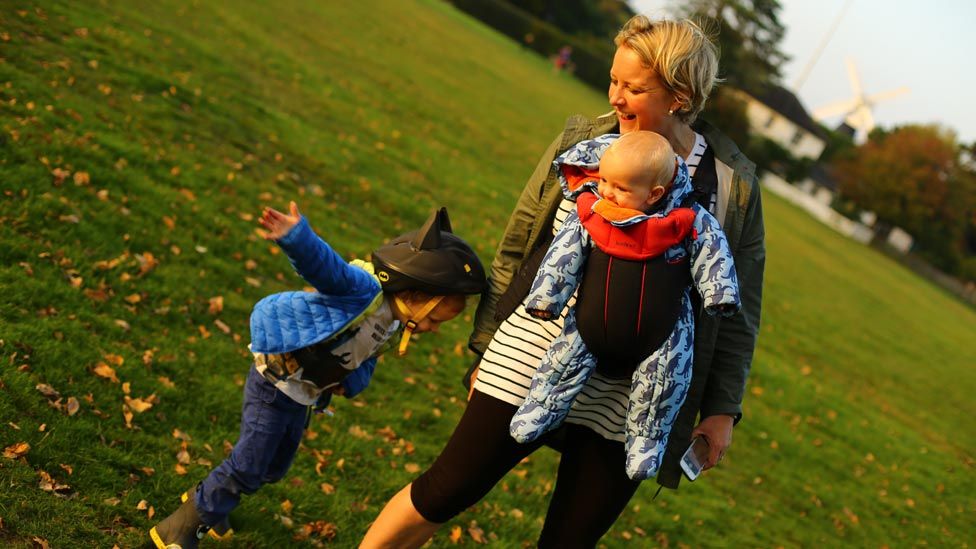 Alexandra Vanotti smiling in the park with her children