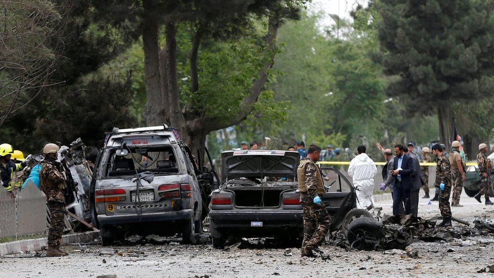 Afghan security forces inspect the site of a suicide attack in Kabul