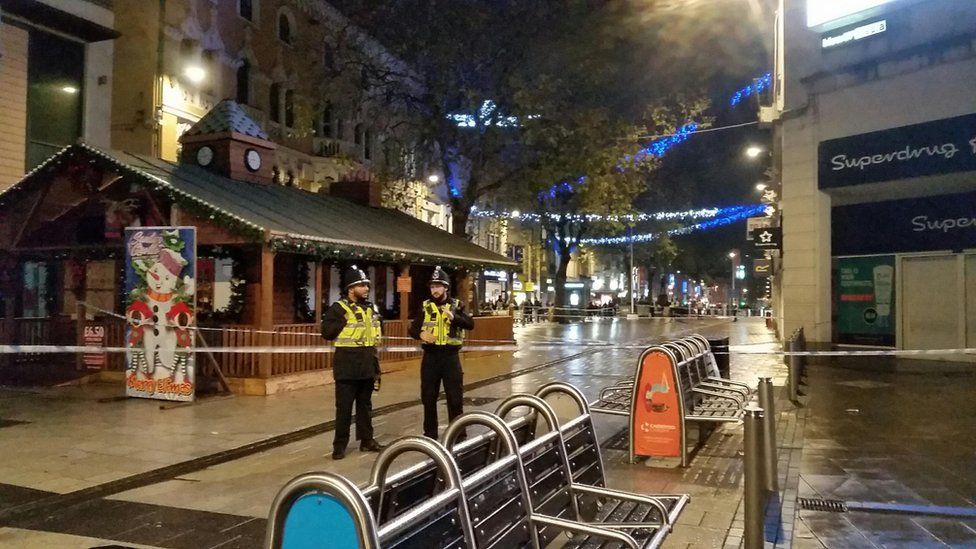 Police standing outside a cordoned off area of Queen St