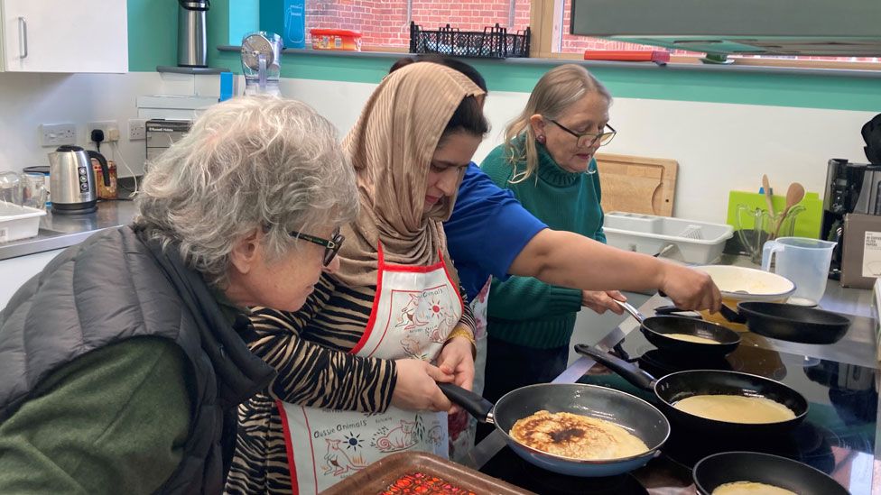 Afghani women learning how to make pancakes