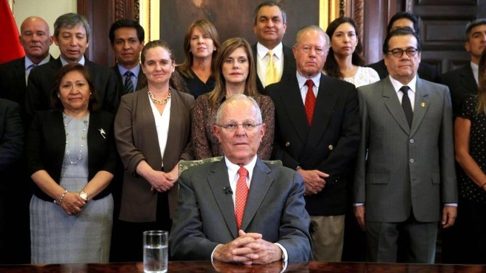 This handout picture released by the Peruvian Presidency show Peruvian President Pedro Pablo Kuczynski (C) posing with his ministerial cabinet standing behind him, at the Palace of Government in Lima before recording a televised message to the nation, in which he announced his resignation on March 21, 2018