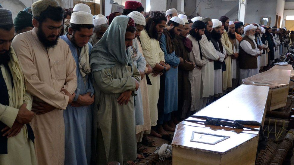 Mourners offer funeral prayers for blast victims