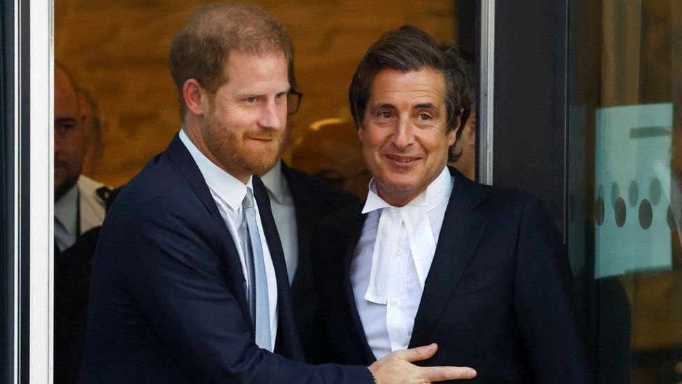 Prince Harry embracing barrister David Sherborne outside London's High Court.