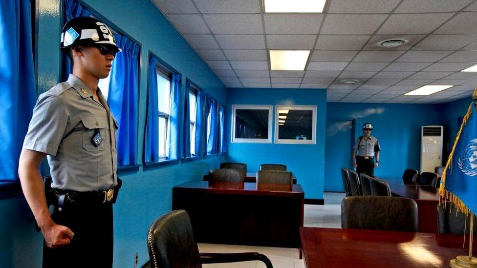 South Korean soldiers stand guards at the Military Demarcation Line in the Demilitarized Zone (DMZ) in the border village of Panmunjom, South Korea, 23 July 2014.