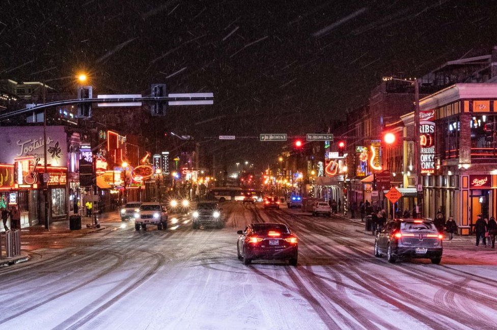 Snow falls on Broadway, a popular tourist street in Nashville, Tennessee, on 22 December 2022