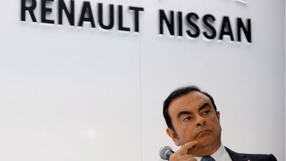 CEO of Renault-Nissan Carlos Ghosn listens while attending a joint press conference along with CEO of German automaker Daimler Dieter Zetsche at the Paris Motor Show on September 30, 2016.