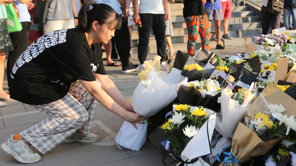 Floral tributes to those who lost their lives when Zhengzhou's subway system became inundated with water