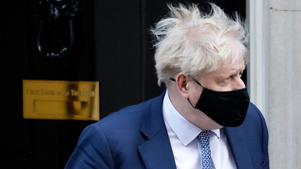 Prime Minister Boris Johnson, wearing a face covering, leaves from 10 Downing Street in London on 12 January 2022