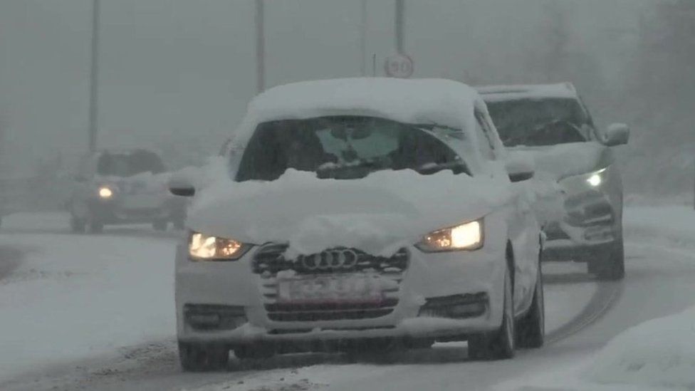 Car driving through snow