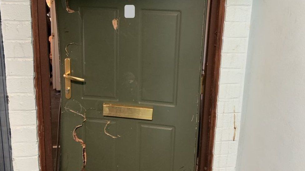 The door of the property after police forced entry to execute the warrant