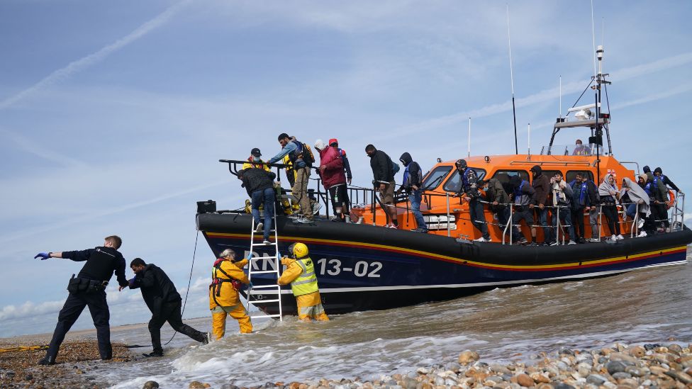 Migrants helped off a lifeboat by RNLI crew and UK Immigration Enforcement officers in Kent - 2021