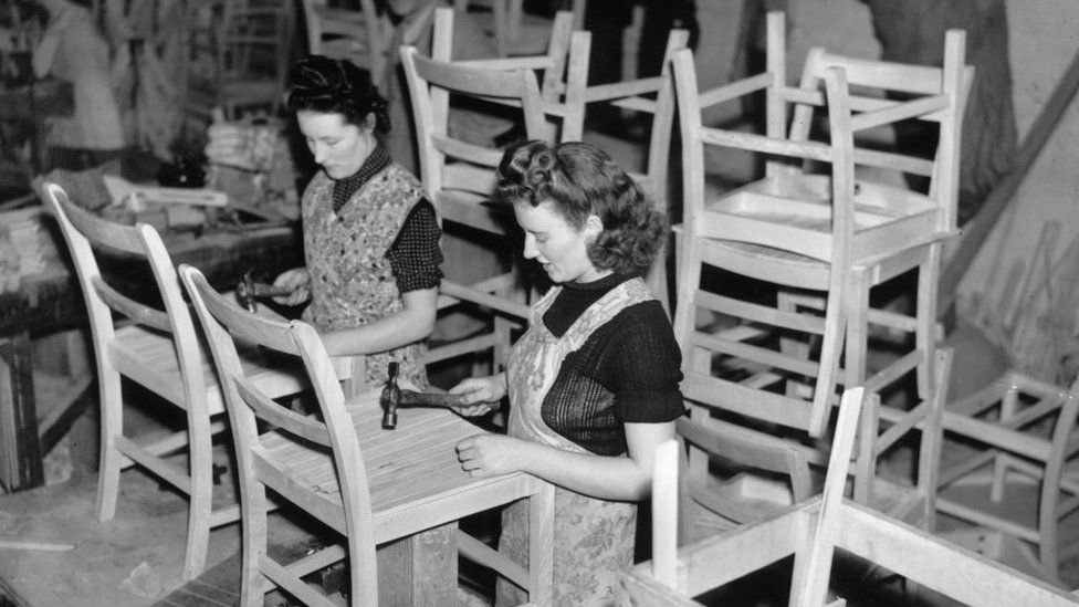 Women making utility furniture which will only be available by permit