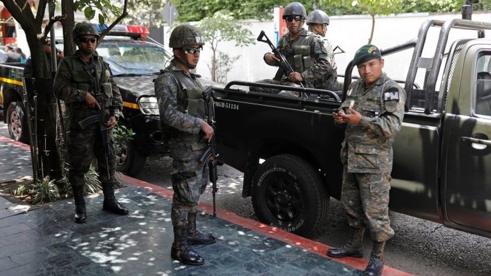 Members of the Guatemalan Military Police stand guard outside a hotel in Guatemala City, Guatemala, July 31, 201