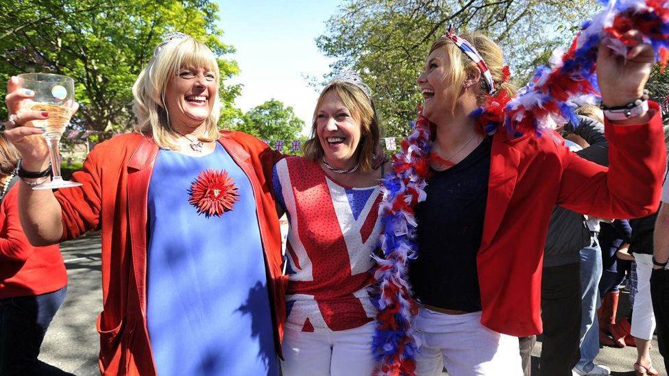 Revellers cheer with Britain's Union flags during a street party to celebrate the Queen's Diamond Jubilee in Edinburgh on 3 June 2012