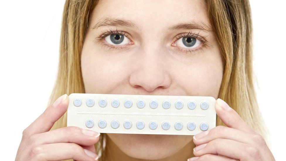 Woman holding the Pill
