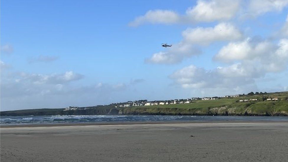 A helicopter was seen hovering over the beach after Mr Morgan rescued the children