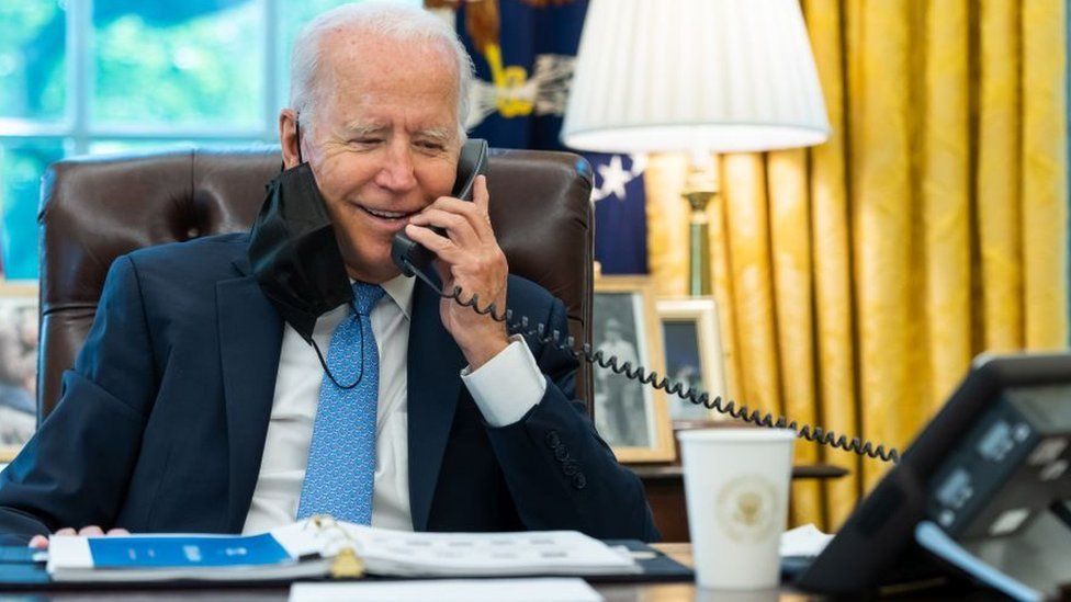 A photo of President Biden making a phone call.