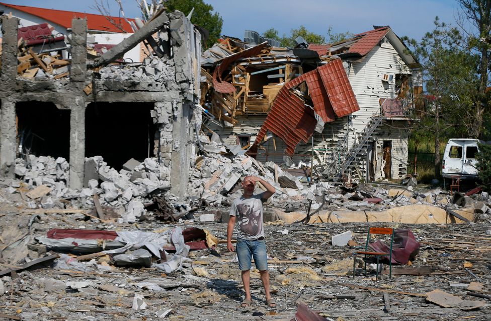 A man looks at the debris after a rocket strike in the Zatoka settlement near the southern Ukrainian city of Odesa. At least four people were injured, according to the State Emergency Service of Ukraine on 18 August 2022