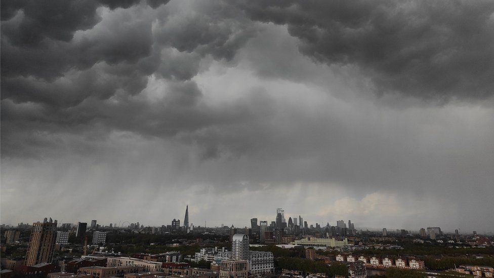Dark clouds above a London skyline.