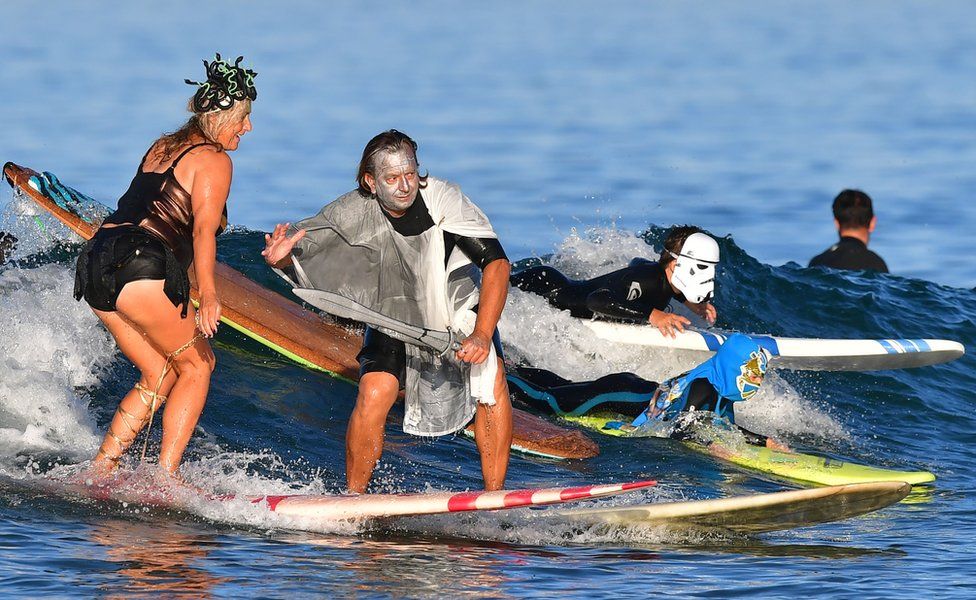 Surfers at the 16th Annual Blackies Halloween Surf event
